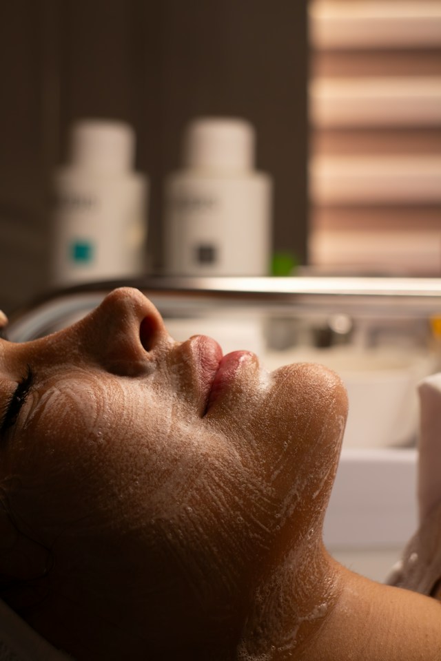 Facial plastic surgeon assessing a patient's nose and cheeks